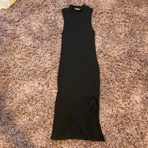 Black ribbed sleeveless dress with slit mock neck